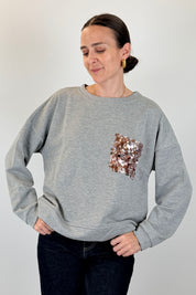 Felpa con tasca paillettes