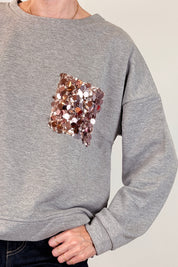 Felpa con tasca paillettes