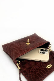 Borsa modello MARTA in pelle effetto pitonato con chiusura dorata a forma di ape, dettaglio della borsa aperta, vista di tre quarti